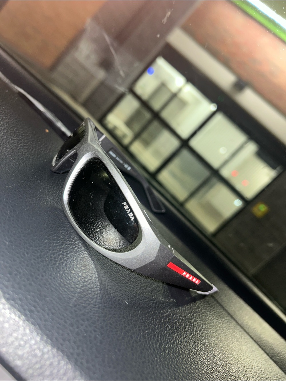 Prada Gray Sunglasses with Red Temple Detail